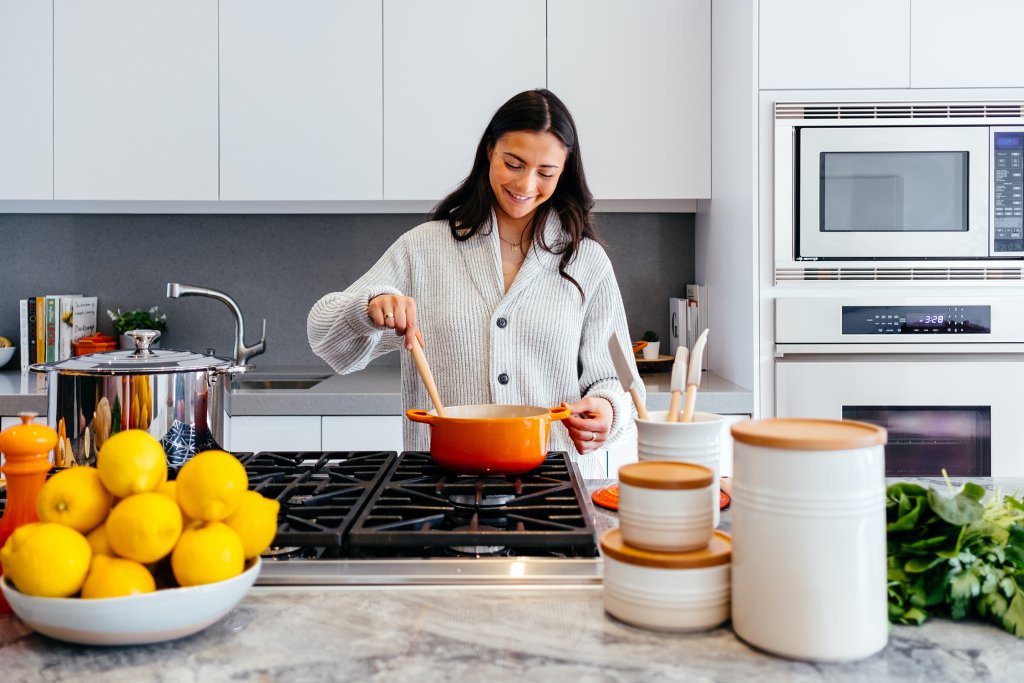 Woman cooking in kitchen. Photo by Jason Briscoe of Burst.